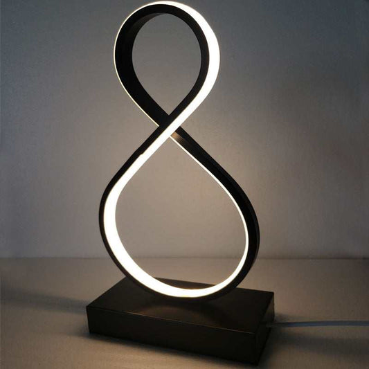 Modern spiral bedside table lamp with warm ambient lighting on nightstand